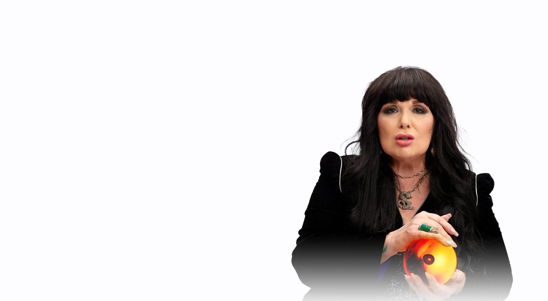 Ann Wilson holding an orange orb on a white background