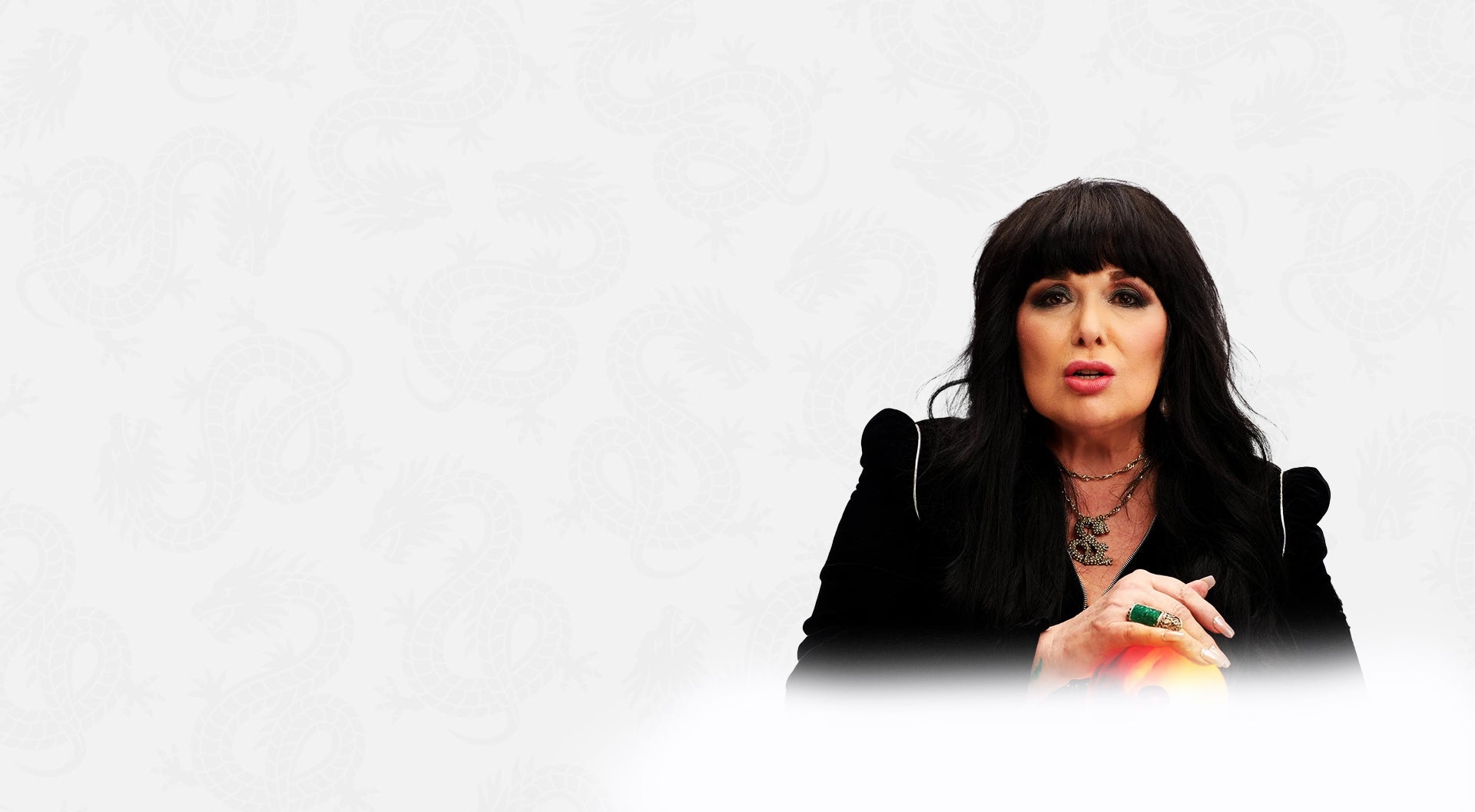 Woman with dark hair and black outfit on a white background