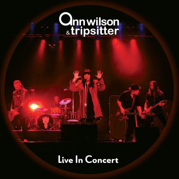 Band performing on stage with red lighting and 'Ann Wilson & Tripsitter' text.
